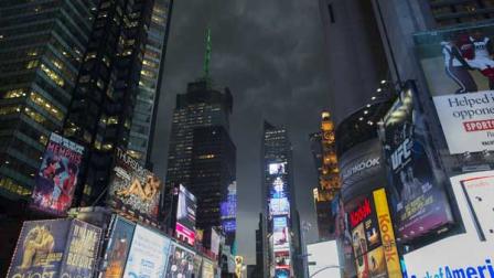 Storm clouds loom over Times Square as Manhattan braces for heavy weather, Thursday, July 26, 2012, in New York. The storm resulted in more than 20,000 customers without power in the Elmira area in upstate New York, where buildings were damaged, power lines and trees toppled, and hospitals placed on disaster status after a possible tornado hit the city Thursday afternoon.
