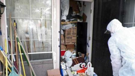 This photo provided by the City of Las Vegas via the Las Vegas Review-Journal shows a worker during a cleanup of the interior of hoarder Kenneth Epsteins home in Las Vegas. Officials began hauling away items from Kenneth Epsteins home on Friday, Oct. 5, 2012 after they found materials stacked from floor to ceiling inside and declared it uninhabitable, the Las Vegas Review-Journal reported. In all, a private removal company was working with officials to remove about 15 truckloads of materials.