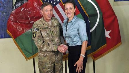 This photo made available on the International Security Assistance Forces Flickr website shows the former Commander of International Security Assistance Force and U.S. Forces-Afghanistan Gen. Davis Petraeus, left, shaking hands with Paula Broadwell, co-author of All In: The Education of General David Petraeus.