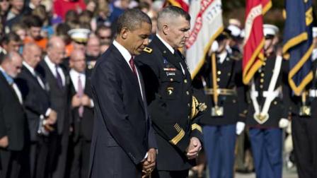 During a solemn Veterans Day ceremony, President Barack Obama presents a wreath at the Tomb of the Unknowns at Arlington National Cemetery in Arlington, Va., Sunday, Nov. 11, 2012. He is accompanied by Maj. Gen. Michael S. Linnington, commander of the U.S. Army Military District of Washington. 