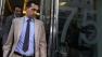 Race horse trainer Mahmood al-Zarooni leaves after a disciplinary hearing at the British Horseracing Authority, in London.