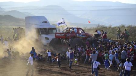 People run as an out of control monster truck plows through a crowd of spectators at a Mexican air show in the city of Chihuahua, Mexico, Saturday Oct. 5, 2013. According to authorities, at least 8 people were killed and 80 were injured. 
