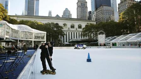 Debris is swept from the ice skating rink at Bryant Park in New York, Sunday, Nov. 10, 2013. (AP Photo/Peter Morgan)