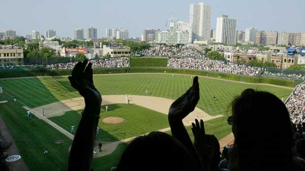 Baseball fans cheer in the upper deck of Wrigley field in Chicago during a game between the Chicago Cubs and the St. Louis Cardinals in this Aug. 30, 2002. [FILE]
