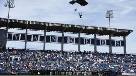 A sky diver from the U.S. Special Operations Command out of MacDill Air Force Base in Tampa, Fla., descends into Legends Field before a spring training baseball game between South Florida and the New York Yankees on Friday, Feb. 29, 2008, in Tampa, Fla.