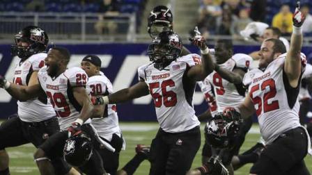 The Northern Illinois team rushes the field after their 44-37 win over Kent State in the second overtime of the Mid-American Conference championship NCAA college football game on Friday, Nov. 30, 2012.