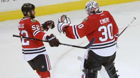 Chicago Blackhawks left wing Brandon Bollig (52) celebrates with goalie Ray Emery after a shootout period of an NHL hockey game against the Vancouver Canucks Tuesday, Feb. 19, 2013 in Chicago. The Blackhawks won 4-3.