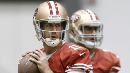San Francisco 49ers quarterbacks Alex Smith (11) and Colin Kaepernick, right, throw during practice in New Orleans.