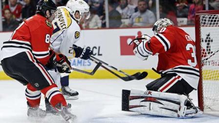 Chicago Blackhawks goalie Ray Emery makes a save on Nashville Predators Patric Hornqvist during the first period as Blackhawks defenseman Nick Leddy watches for a rebound in an NHL hockey game in Chicago.