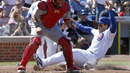 Chicago Cubs Anthony Rizzo, left, scores past St. Louis Cardinals catcher Yadier Molina on a double by Nate Schierholtz, also scoring Luis Valbuena, during the fourth inning of a baseball game, Wednesday, May 8 2013, in Chicago.