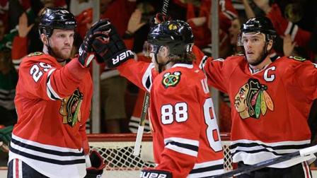 Chicago Blackhawks Bryan Bickell (29), left, celebrates with Patrick Kane (88) and Jonathan Toews (19) after scoring his goal against the Minnesota Wild during the second period in Game 5 of an NHL hockey second-round playoff series in Chicago,Sunday, May 11, 2014. (AP Photo/Nam Y. Huh)

