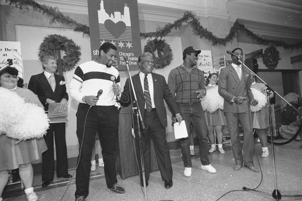 Chicago Mayor Harold Washington, center, laughs...
