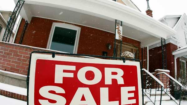 A sale sign stands outside a home on the market. (AP)