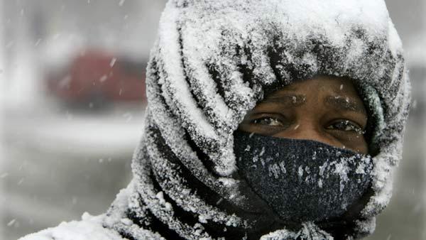 Fred Wilborn is covered in snow as he walks on the south side of Chicago. (AP Photo)