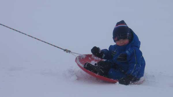 A young child is pulled on a sled near Montrose Harbor in Chicago.