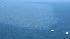 Two ships float near in a massive oil slick...