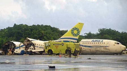 A plane that crashed lays in pieces along the runaway at the airport on San Andres island in Colombia, Monday Aug. 16, 2010. The Boeing 737 operated by the airline Aires crashed on landing after departing from Bogota around midnight local time with 131 passengers. According to an Air Force official, at least one passenger died.