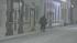 A pedestrian shields their face from the falling...
