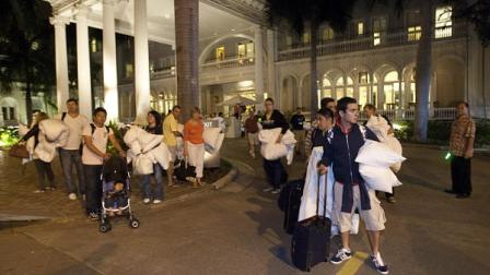 Hotel guests from the Moana Surfrider evacuate early Friday, March 11, 2011 in Honolulu. The state of Hawaii is under a tsunami warning due to a large 8.9 earthquake which struck off Japan. The earthquake is believed to have generated a tsunami wave. The Pacific Tsunami Center expects the wave to hit Oahu at 3:21 a.m. Hawaiian Standard Time.
