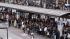 Commuters wait in a long queue at a bus terminal...