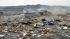 Houses, cars and other debris are washed away by...