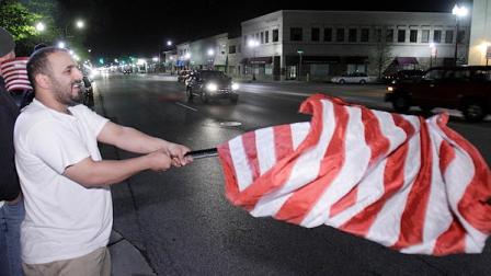 Toufeq Ahmed waves a flag as he celebrates the news of the death of Osama Bin Laden in Dearborn, Mich., early Monday, May 2, 2011. President Barack Obama announced Sunday night, May 1, 2011, that Osama bin Laden was killed in an operation led by the United States.