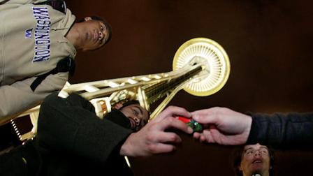 From left, Andre Edwards, G.E. Montoya, and J. Smiley pass around a glass pipe as they smoke marijuana, Thursday, Dec. 6, 2012, just after midnight at the Space Needle in Seattle. Possession of marijuana became legal in Washington state at midnight, and several hundred people gathered at the Space Needle to smoke and celebrate the occasion, even though the new law does prohibit public use of marijuana.