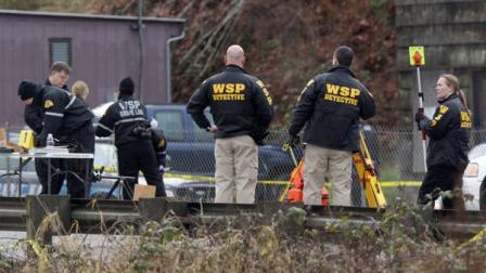 Washington State Patrol officials investigate the scene where a state trooper making a routine traffic stop was shot and killed early Thursday, Feb. 23, 2012, in Gorst, Wash.