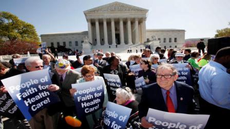 Protesters in favor of health care reform demonstrate outside of the Supreme Court in Washington, Monday, March 26, 2012, as a hearing on President Obamas health care legislation began.