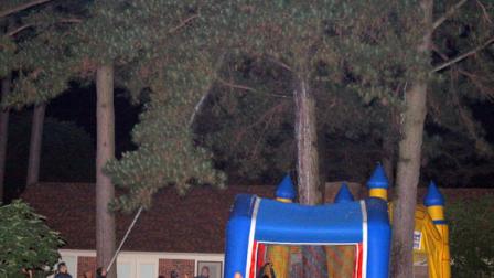 A bear stays parched up a tree as city prepare to tranquilize the bear on April 30, 2012 in Conway, Ark. Officials shot the bear with tranquilizer darts late Monday, causing him to fall asleep. They inflated two bouncy houses, usually reserved for childrens parties, beneath the tree. And then firefighters let loose with water from a fire hose, knocking the bear from his perch. The edge of the inflatable houses broke the bears fall. Wildlife officials plan to release him back into the wild. (AP Photo/The Log Cabin Democrat, Courtney Spradlin)
