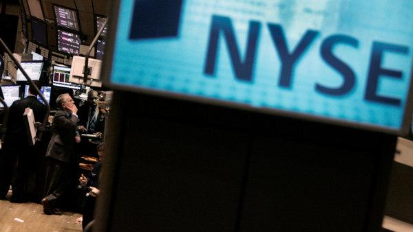 Specialist James Maguire Sr., second left, works at his post on the floor of the New York Stock Exchange Tuesday Jan. 15, 2008.