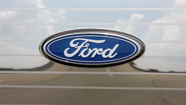 A Ford logo is shown on a Ford Edge front grill in Dearborn, Mich. (AP Photo/Paul Sancya)