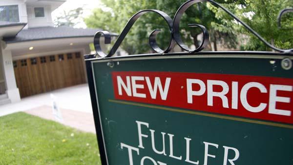 A sign declaring a lower price stands outsidde an existing home on the market n Denver on Sunday, July 20, 2008. (AP Photo/David Zalubowski)