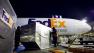 In this Dec. 9, 2010 photo, shipping containers are unloaded from a FedEx cargo plane at the FedEx facility at Newark Liberty International Airport in Newark, N.J. The company is now gearing up for the holidays, when it expects to move nearly 16 million packages on the busiest day, about 11 percent higher than last year. The company benefits from an increase in online holiday gift-buying. (AP Photo/Mark Lennihan) 