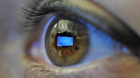 FILE - In this Jan. 11, 2011 file photo, the Skype logo is reflected in the eye of a reader using a handheld smartphone, in Berlin, Germany. Microsoft Corp. is nearing a deal to buy the popular Internet telephone service Skype in what could be the biggest deal in the software makers 36-year history, according to a published report Tuesday, May 10, 2011.