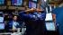 Traders work on the floor of the New York Stock...