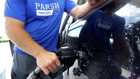 FILE - In this June 30, 2011 file photo, a motorist pumps gasoline into his vehicle at an Exxon gas station, in Farmers Branch, Texas.