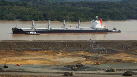 A ship sails at the Panama Canal near an area under construction as a part of its expansion project in Panama City, Wednesday, Dec. 21, 2011.
