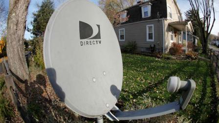 This photo made with a fisheye lens on Nov. 2, 2011, shows a DirecTv satellite dish on a post in the front yard of a home in Harmony, Pa. (AP Photo/Keith Srakocic)