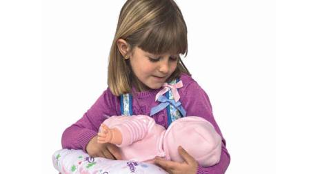 This product image released by Berjuan Toys shows a girl playing with The Breast Milk Baby doll. The breastfeeding doll, whose suckling sounds are prompted by sensors sewn into a halter top, has caught some flak after hitting the U.S. market. (AP Photo/Berjuan Toys)