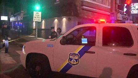 Police look for evidence after a man was shot during a robbery in Philadelphias Olney section. He later died.