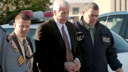 In this photo provided by the Pennsylvania Office of Attorney General, former Penn State football defensive coordinator Gerald Jerry Sandusky, center, walks to the office of Centre County Magisterial District Judge Leslie A. Dutchcot while being escorted by Pennsylvania State Police and Attorney Generals Office officials on Saturday, Nov. 5, 2011, in State College, Pa. (AP Photo/Pennsylvania Office of Attorney General via Commonwealth Media Services)