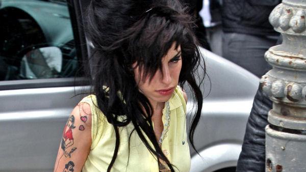 British singer Amy Winehouse arrives at a police station in London, Friday April 25, 2008, where she voluntarily appeared to be questioned in connection with an alleged assault that took place in the north London neighborhood of Camden. (AP Photo/Anthony Devlin, PA)