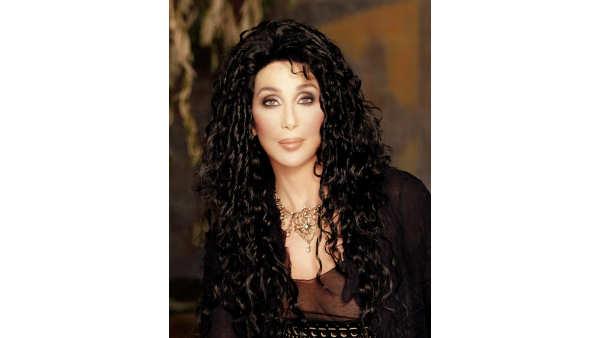 In this undated photo released by Sothebys and Juliens, Cher poses for a photograph. Cher is auctioning off hundreds of items from her Malibu home beginning Oct. 3, Cher announced Monday, July 31, 2006. A nice percentage of the proceeds will benefit the Cher Charitable Foundation, Cher said. (AP Photo/Sothebys/Juliens, Michael Levine)