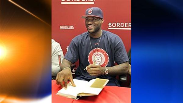 NBA star LeBron James smiles at a fan as he signs a copy of his new book Shooting Stars at a Borders bookstore in Westlake, Ohio on Friday, Sept. 18, 2009. In the book, co-authored with Buzz Bissinger, James tells the story of his rise from Akron, Ohio, hoops prodigy to NBA superstar. (AP Photo/Amy Sancetta)
(AP)