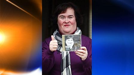 British singer Susan Boyle displays a copy of her CD, at the front door of her house in Blackburn, Scotland, Saturday Nov. 28, 2009. Susan Boyles debut record, I Dreamed A Dream, entered the British album chart in the top spot Sunday. (AP Photo/Andrew Milligan, PA)
(AP)