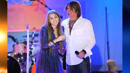 Singer Miley Cyrus, left, and her father singer Billy Ray Cyrus perform together on ABCs Good Morning America, Wednesday, April 8, 2009 in New York. (AP Photo/Evan Agostini)
