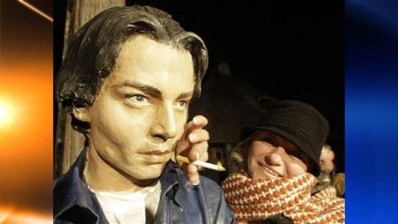 A woman poses with the bust of U.S. actor Johnny Depp in the village of Drvengrad, at Mt. Mokra Gora, in south Serbia, Wednesday, Jan. 13, 2010.