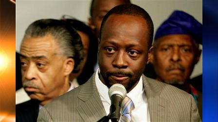 Haitian musician and humanitarian Wyclef Jean, center, is joined by clergy including the Rev. Al Sharpton, left, and the Rev. Herbert Daughtry, right, during a news conference pledging their support to Yele, the humanitarian and relief organization headed by Jean in New York, Wednesday Jan. 27, 2010.