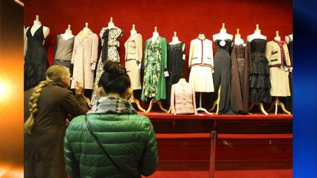 Visitors watch Chanel dresses exhibited at a Paris auction house, Thursday Feb. 25, 2010. Some 600 garments, accessories and shoes by the storied luxury giant Chanel hit Paris auction blocks, with lots at the two-day-long sale including haute couture dresses designed by Mademoiselle Chanel herself. (AP Photo/Jacques Brinon)